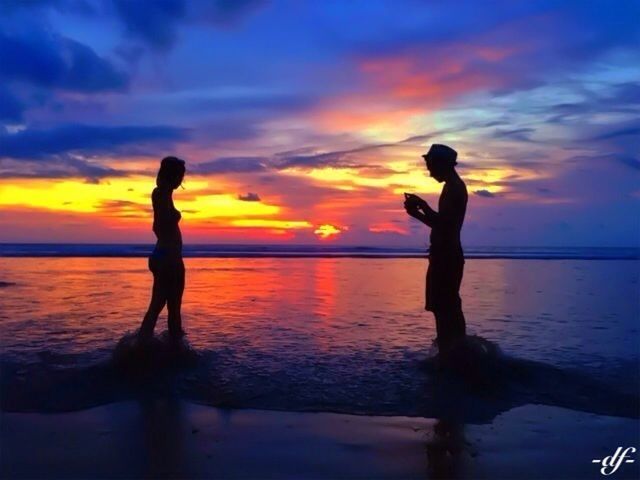 sunset, silhouette, water, sea, sky, scenics, beauty in nature, horizon over water, orange color, standing, tranquil scene, tranquility, beach, idyllic, cloud - sky, reflection, leisure activity, lifestyles