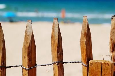 Close-up of wooden fence against blue sky