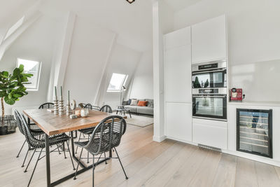 Empty chairs with dining table at living room