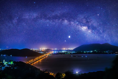 Scenic view of illuminated mountains against sky at night