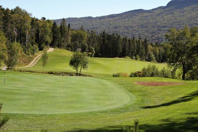 Scenic view of golf course against sky