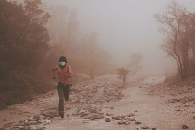 A man runs in the morning mist