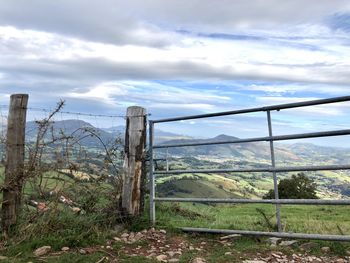 Fence on field against sky