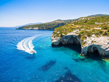 Scenic view of bay against clear blue sky