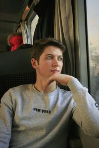 Portrait of young man sitting in car