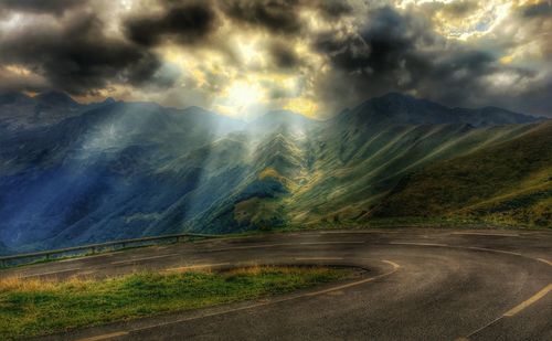 Scenic view of mountains against cloudy sky