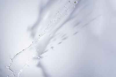 Close-up of water splashing against wall