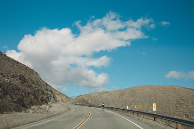 Road amidst mountains against sky