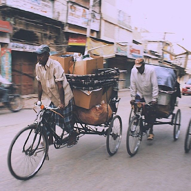 bicycle, mode of transport, transportation, land vehicle, stationary, parked, building exterior, parking, street, architecture, men, built structure, riding, city, city life, travel, motorcycle, side view, motor scooter