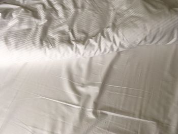 High angle view of shadow on bed