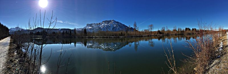 Panoramic view of lake against clear blue sky