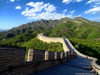 Great wall of china on green mountain against sky