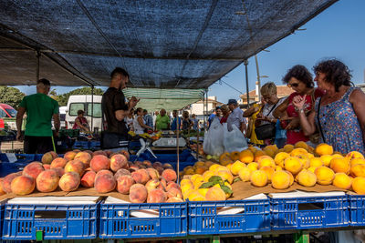 People for sale at market stall