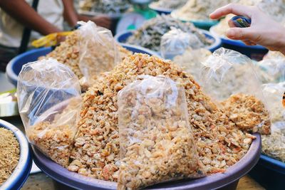 Close-up of man preparing food for sale in market