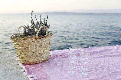 Close-up of drink on table at beach