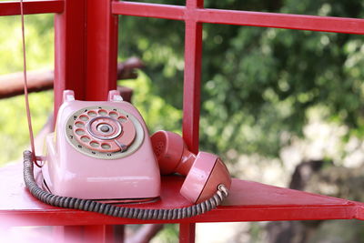 Close-up of telephone booth on table