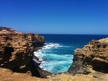 Scenic view of sea against clear blue sky