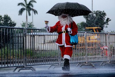 Full length of man with umbrella