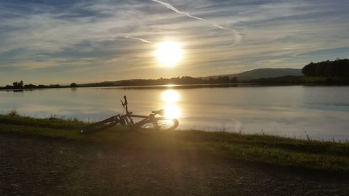 Scenic view of lake against sky during sunset
