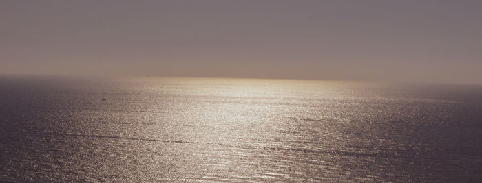 Scenic view of sea against clear sky during sunset