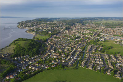 High angle view of buildings and sea against sky