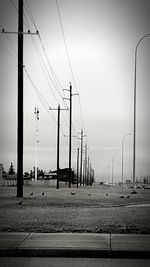 Cars on street against clear sky