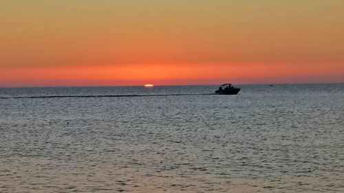 Scenic view of sea against clear sky during sunset