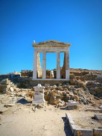 Low angle view of old ruin against clear blue sky