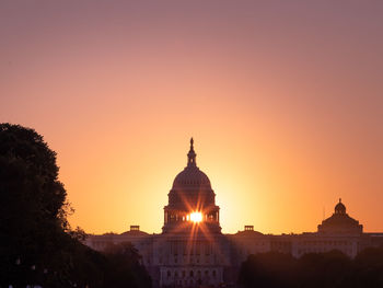 Silhouette building against sky during sunset