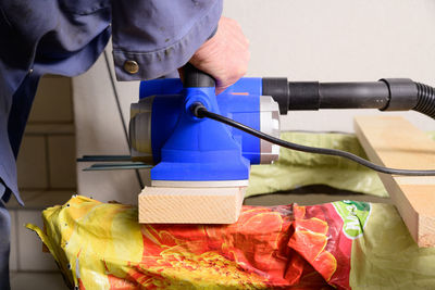 Midsection of man working on barbecue grill