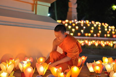 Young man with illuminated candles