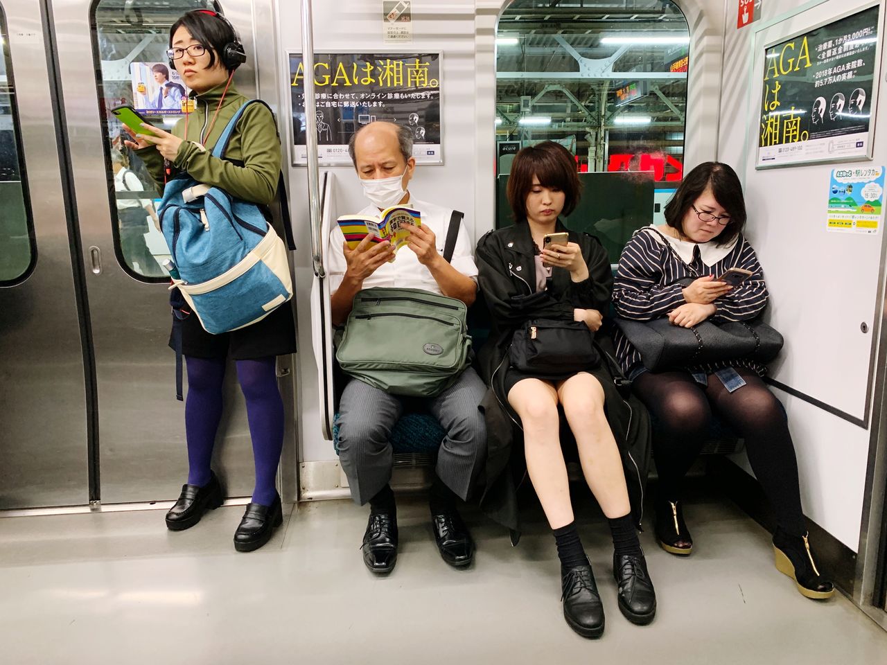 FULL LENGTH PORTRAIT OF FRIENDS SITTING IN CORRIDOR