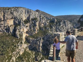 Rear view of daughter and father at verdon gorge