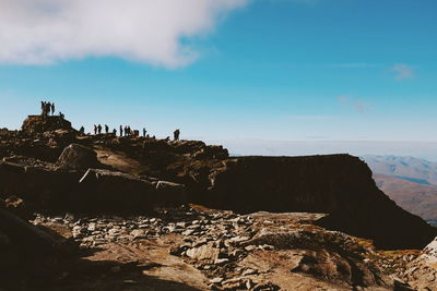Scenic view of cliff by sea against sky