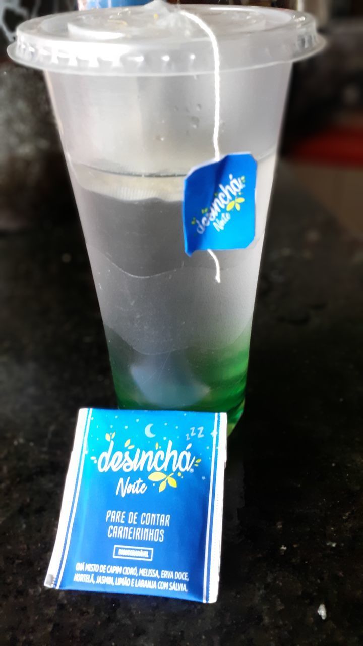 HIGH ANGLE VIEW OF DRINK WITH TEXT ON BLUE BACKGROUND