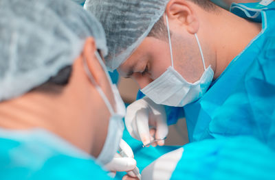 Midsection of doctor examining patient in hospital