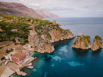 Scenic view of sea and mountains against sky