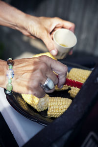 Woman preparing corn on cobs, sweden