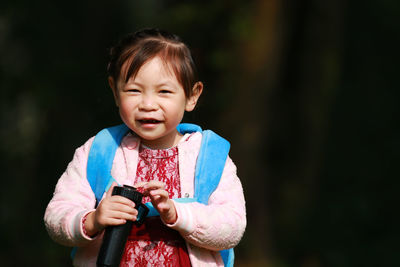 Portrait of cute girl standing in park