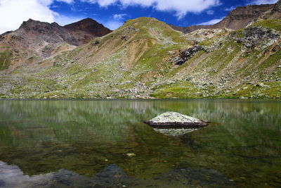 Scenic view of lake and mountains against sky