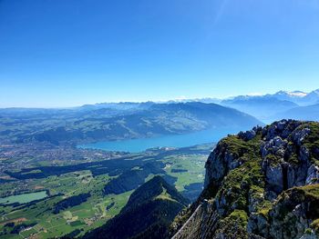 Scenic view of mountains against clear blue sky