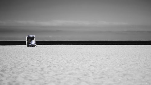 Lifeguard hut on beach against sky