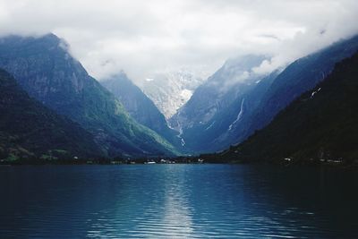 Scenic view of lake and mountains against sky