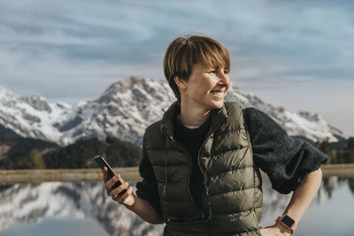 Man using smart phone while standing on mountain