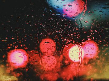 Close-up of wet illuminated lights