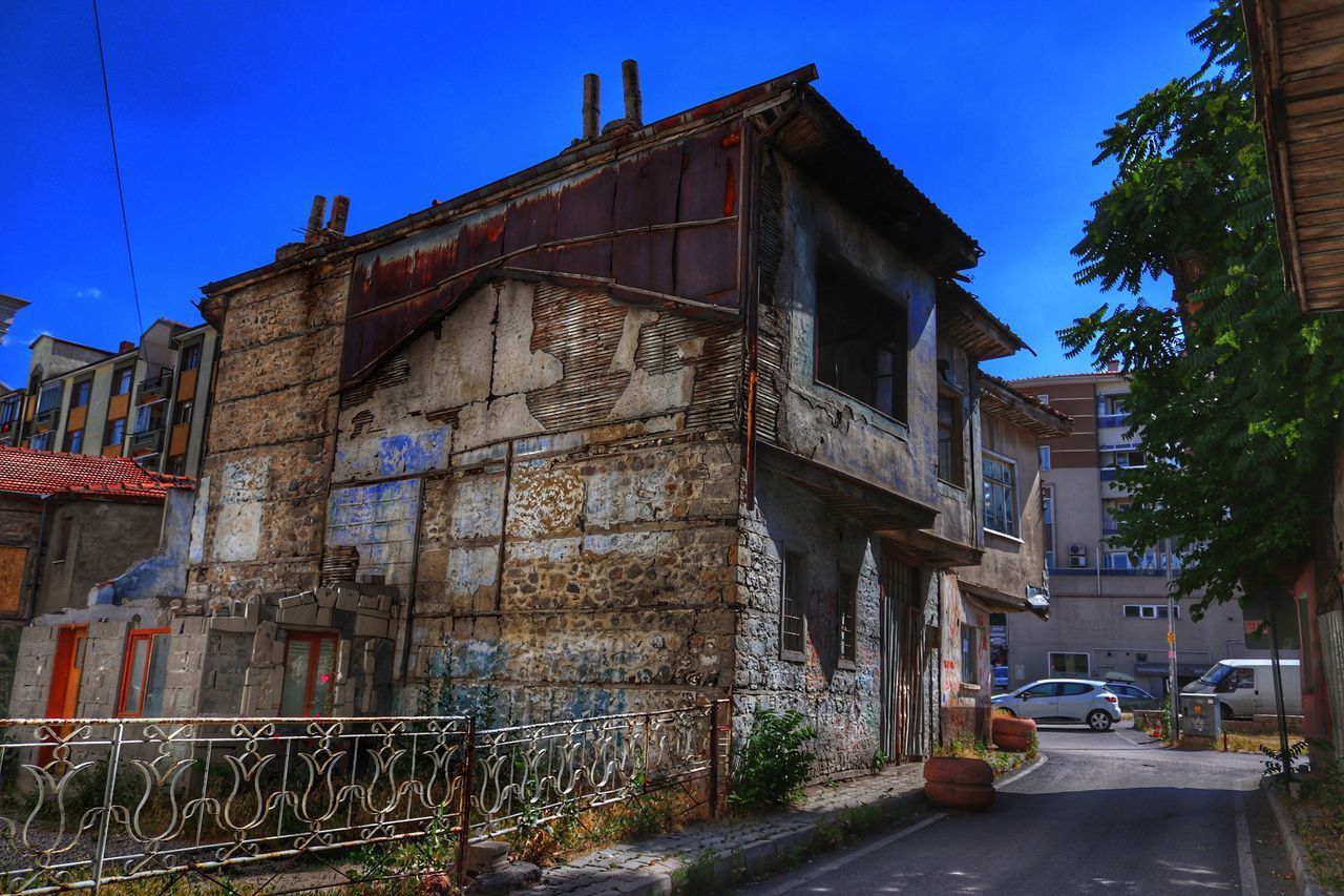 STREET BY BUILDING AGAINST SKY