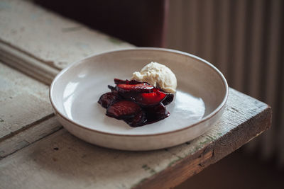 High angle view of vanilla ice cream and fruits on plate