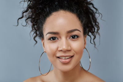 Close-up of young woman with curly hair