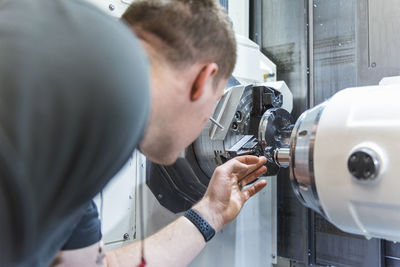 Man working at machine in factory