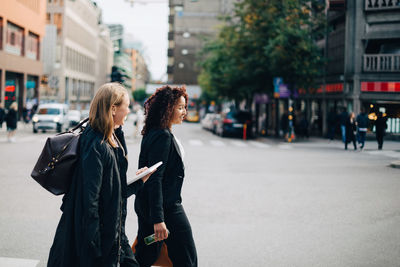 Women walking on street in city